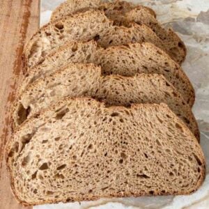 Slices of whole grain sourdough made with hard red wheat on a cutting board.