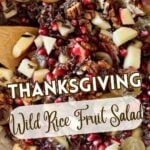 a bowl of wild rice fruit salad with wooden spoon and text for Pinterest.