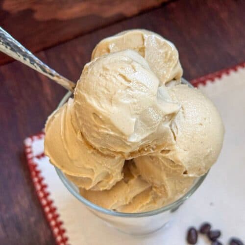 This is a bowl of ninja creami coffee ice cream on a white napkin with a spoon.