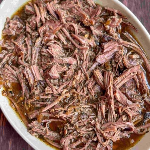 overhead view of shredded sirloin tip roast in gray platter