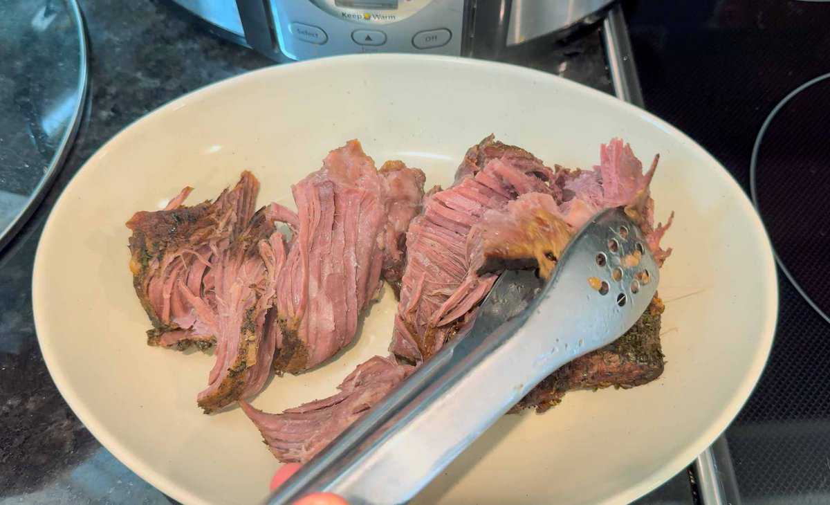 Pieces of sirloin tip roast on tan platter.