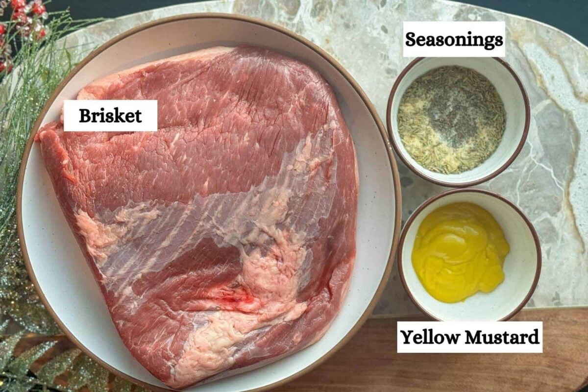 christmas brisket ingredients on marble cutting board.