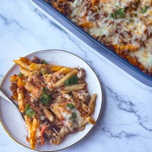 side plate with a portion of high protein pasta bake next to the full pan.