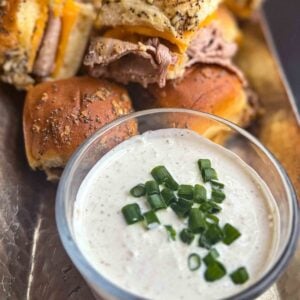 horseradish sauce in bowl on silver tray with roast beef sliders