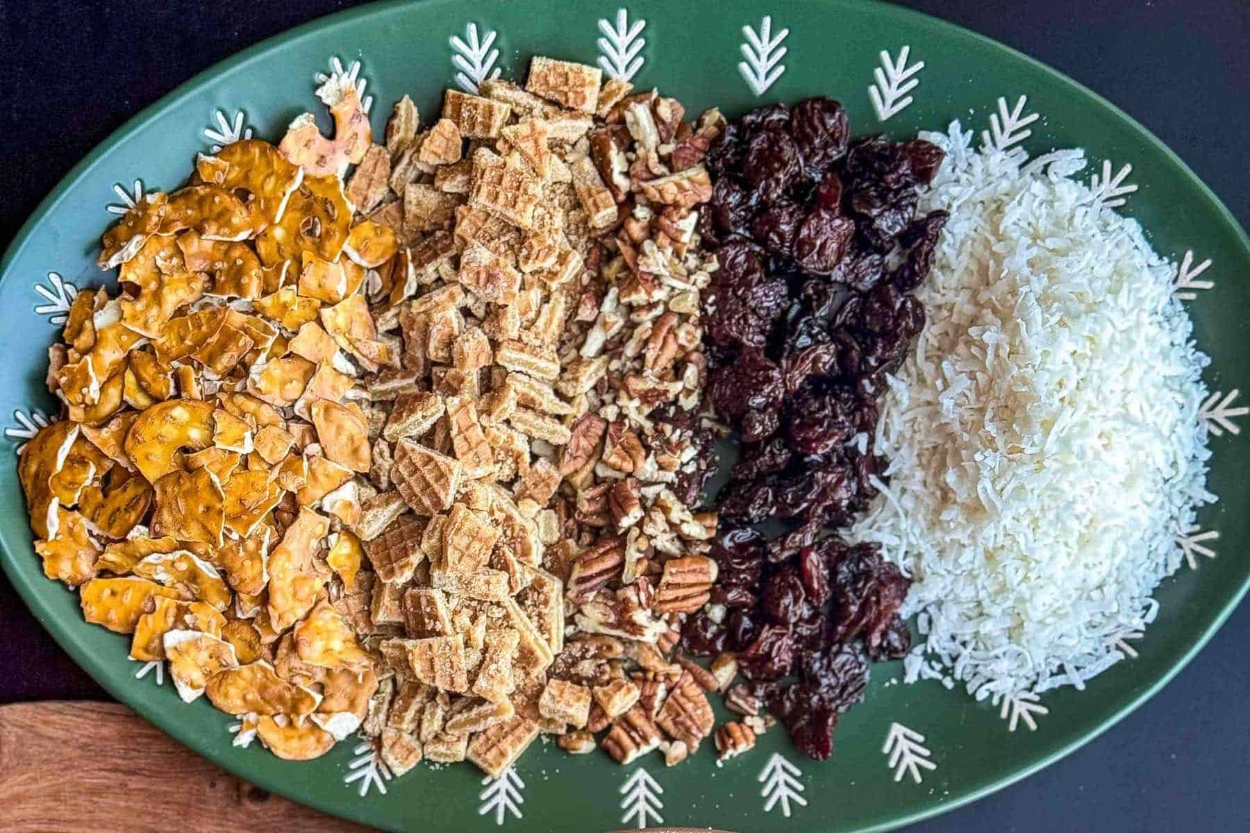 prepped and chopped christmas crack ingredients on green plate.