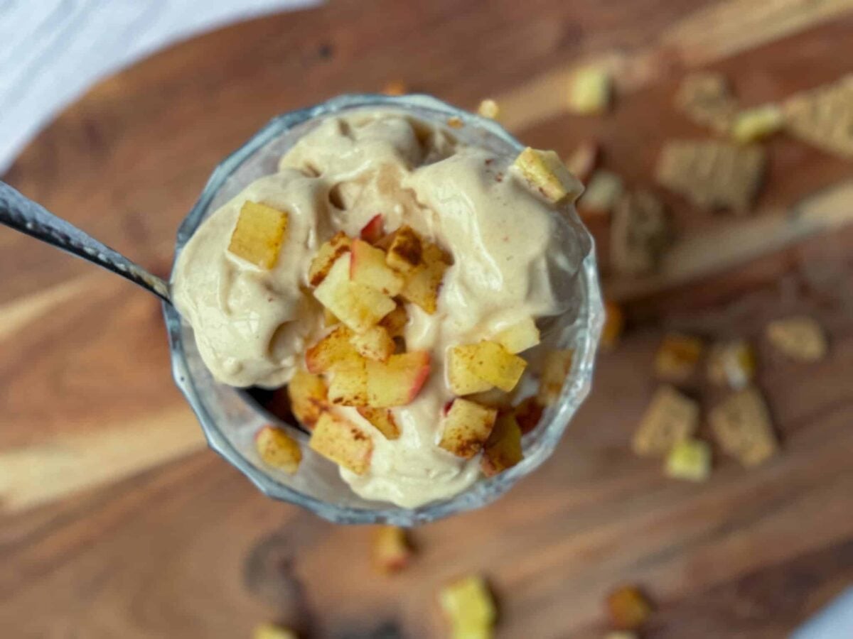 ninja creami cinnamon ice cream in bowl with chopped cinnamon apples on cutting board