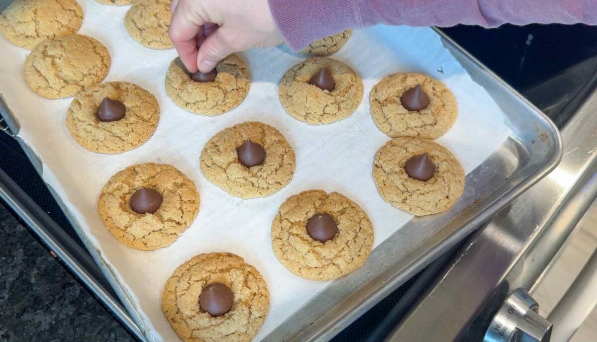 Putting Hershey kisses in the middle of the baked cookies.