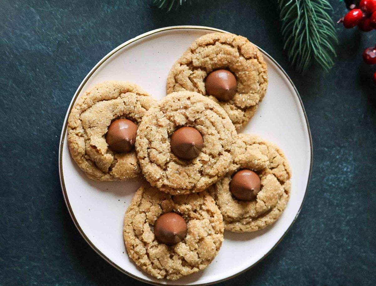 A plate of whole wheat peanut butter blossoms Christmas cookies.