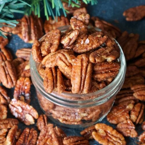 A jar overflowing with maple roasted pecans.