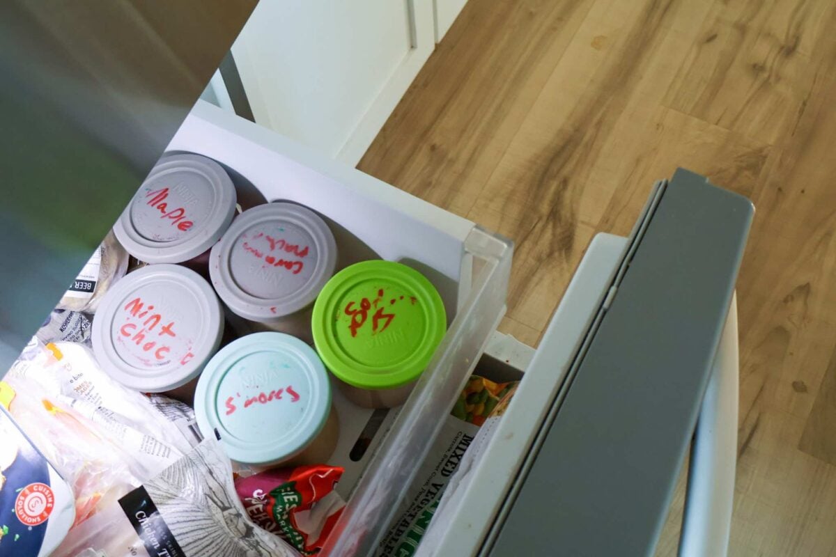 Ninja Creami pints in a freezer drawer.
