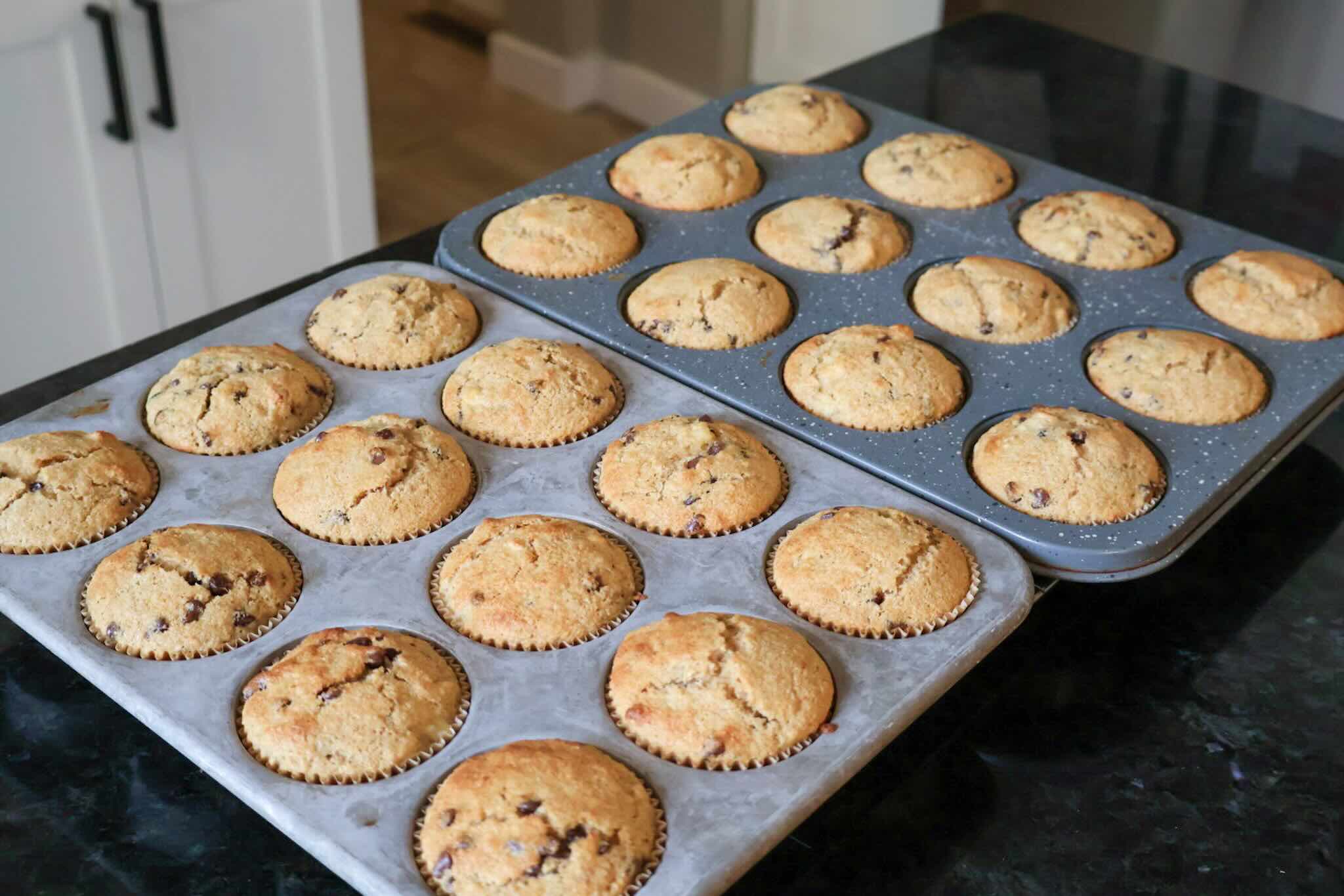 Pans of muffins cooling on the counter.