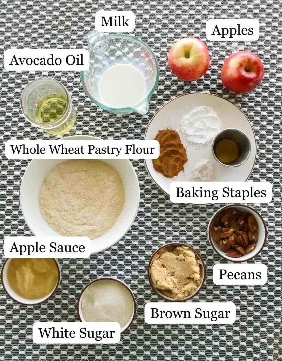 Assortment of apple cake ingredients on a dark table with white lace cloth.