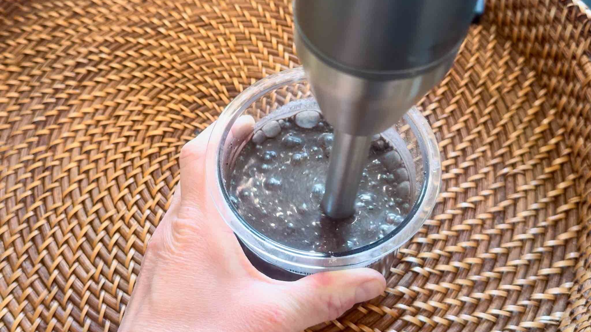 This is an immersion blender blending the pint cup of ingredients.
