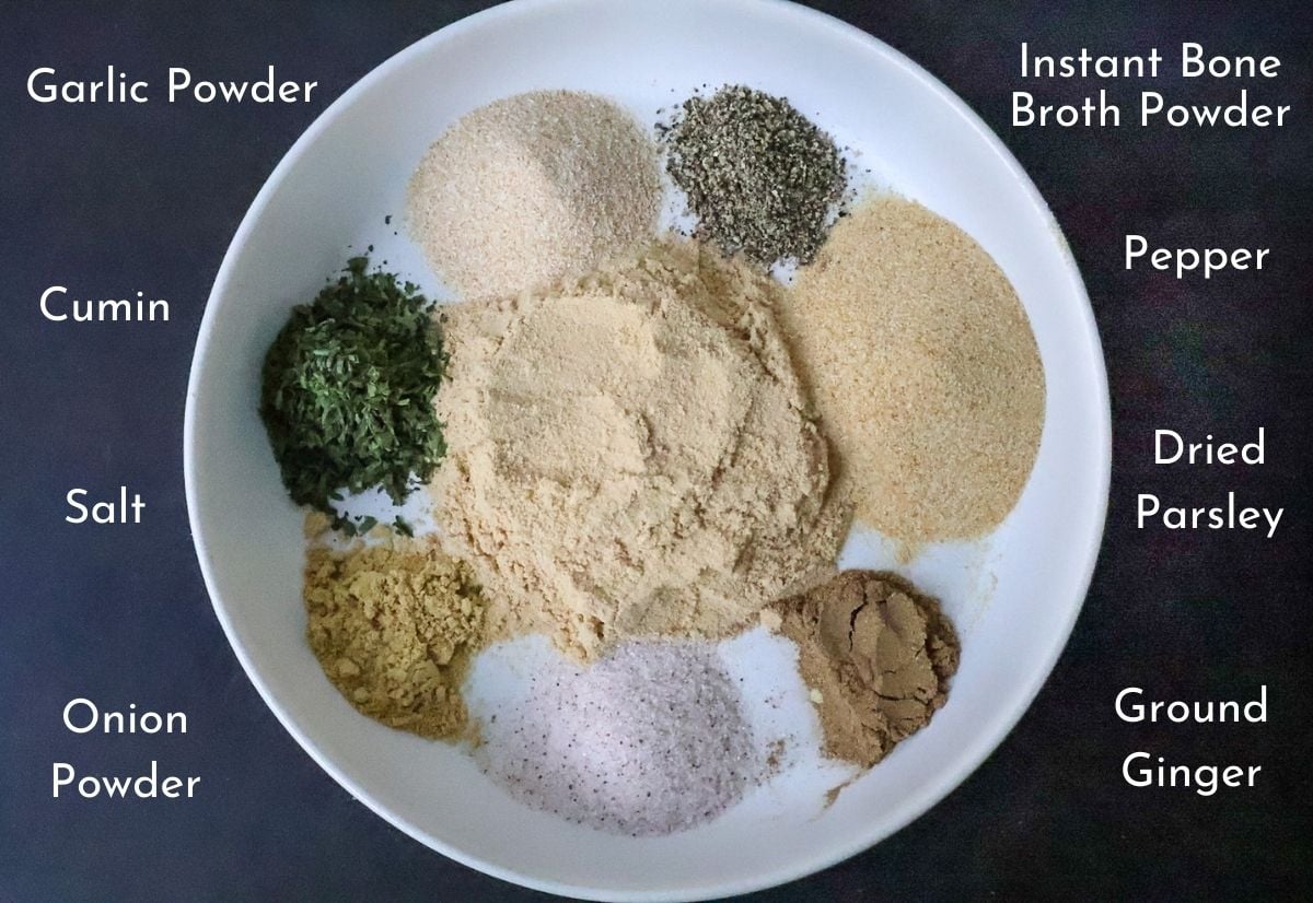 A white plate filled with ramen seasonings on a black backdrop.